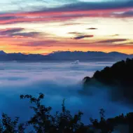 Sunrise in switzerland from a mountain where the clouds are at the bottom